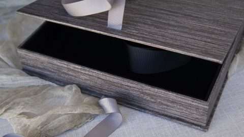 Featuring a black felt-lined interior with a lift-out ribbon